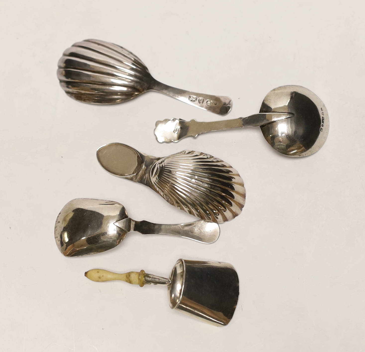Five assorted 19th century silver caddy spoons, including bone handled shovel form, by John Bettridge, Birmingham, 1826, 68mm.